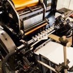 Detailed view of an old-fashioned printing press showing industrial machinery.